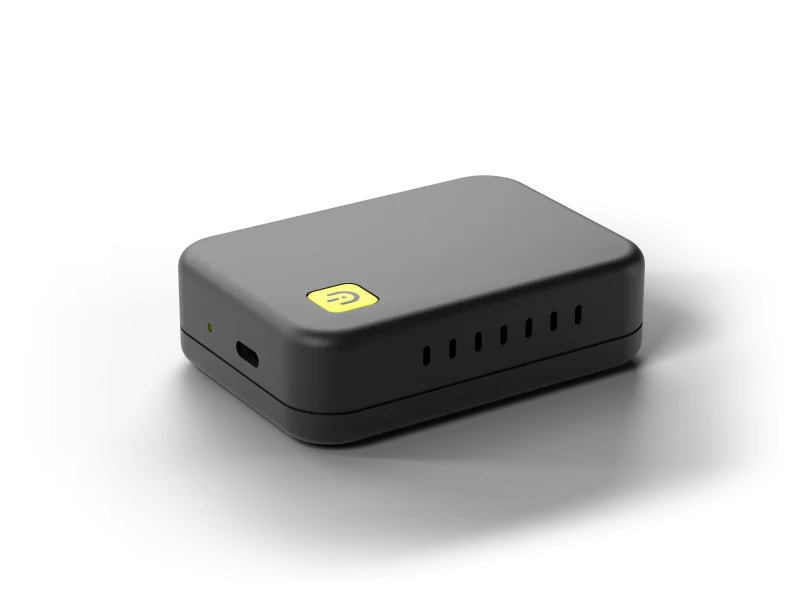 The Dashivo Hub Custom: a compact matte black box with a small yellow Dashivo badge, one USB-C port and a status light.